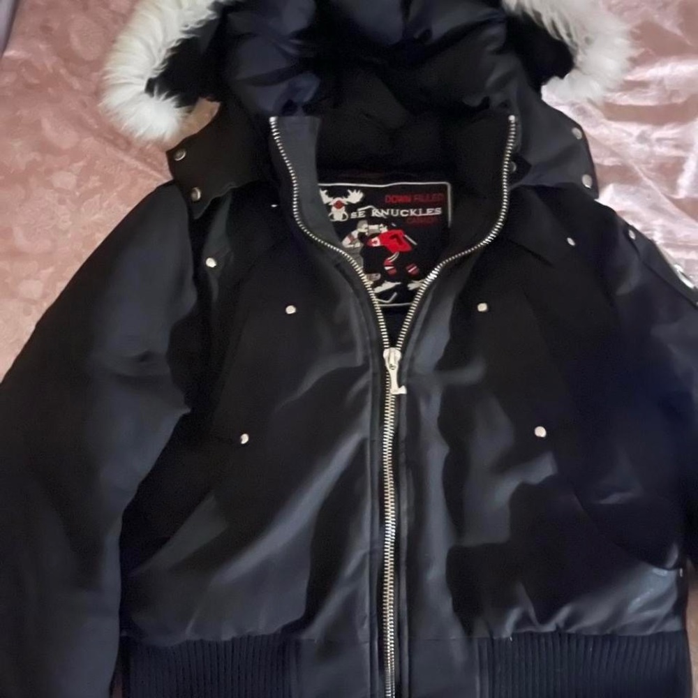 Women Moose Knuckle Black Jacket with White Fur.